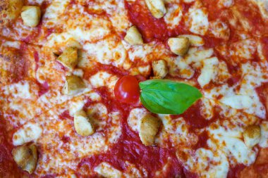 Italian pizza with cheese , tomato and meat on the table . Top view