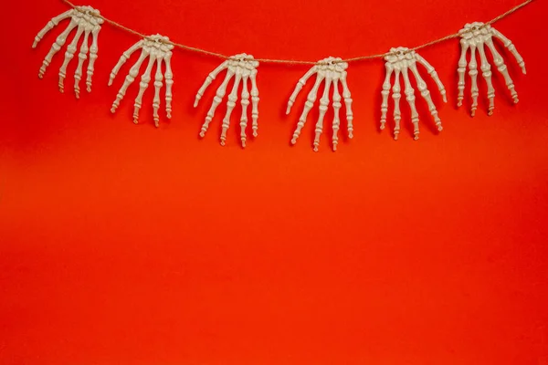 Halloween red card with skeleton hands, background with copy space. Happy halloween banner mockup