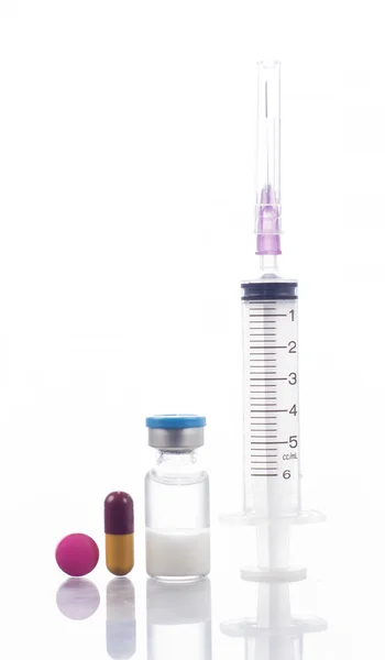 Syringe with red medicine and bottle — Stock Photo, Image