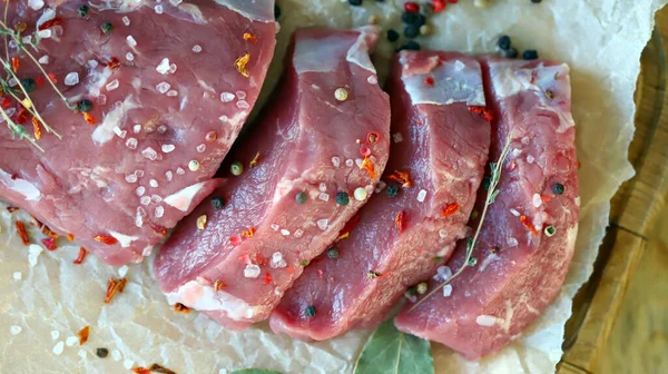 Fresh raw veal in paper. Farmed organic meat.