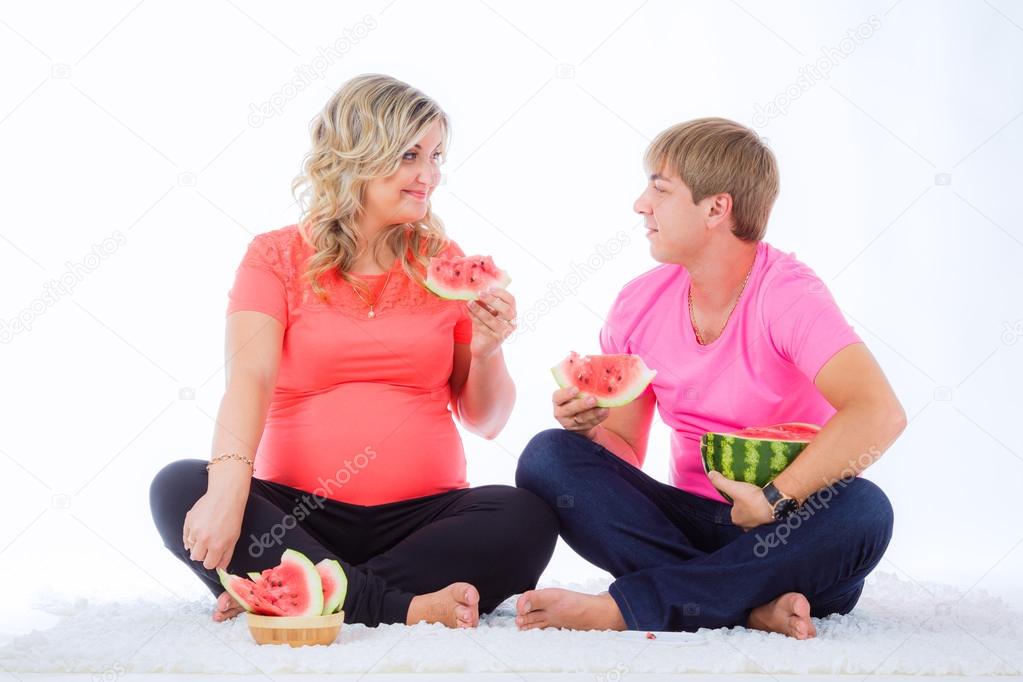 Pregnant woman with husband eating watermelon — Stock Photo © HannaNes