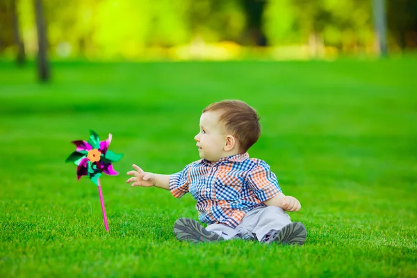 Baby playing with toy in  park.