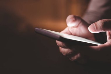 Close up hand of businessman with mobile phone. Concept of technoloy for business.