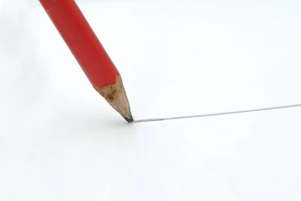 Close-up pencil draw a line isolated on the white background.