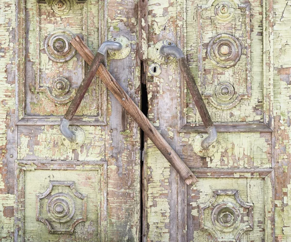 Old painted wooden boarded door — Stock Photo, Image