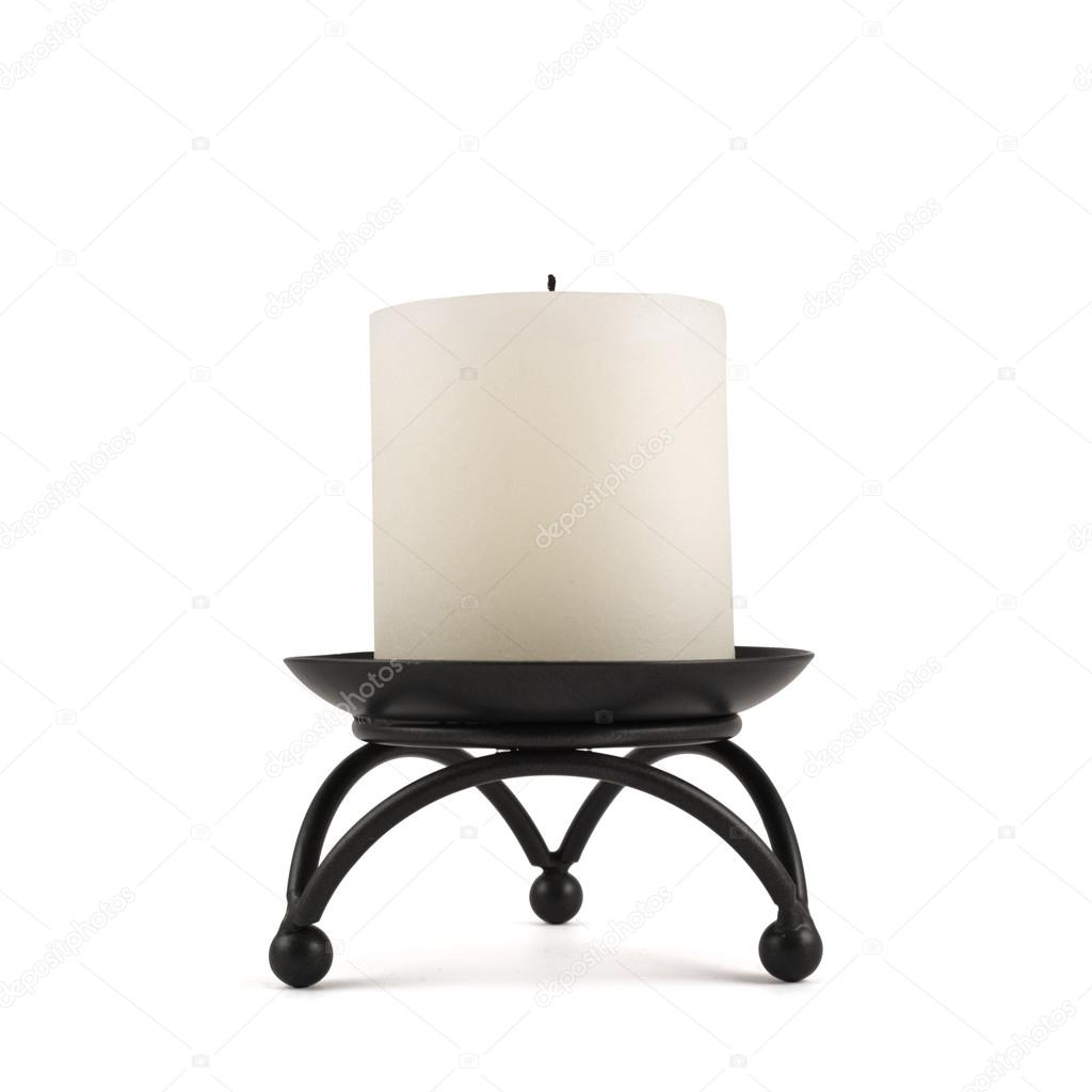 White candle over black metal stand