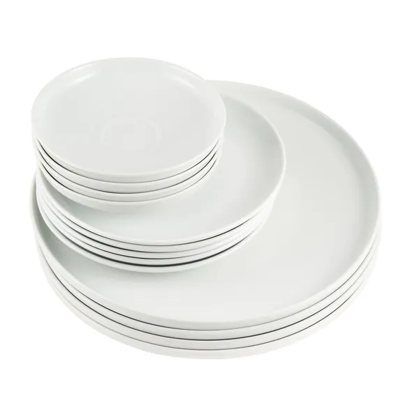 Pile of clean white dish plates isolated — Stock Photo, Image