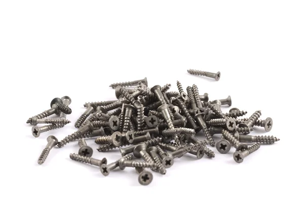 Pile of metal screws isolated — Stock Photo, Image