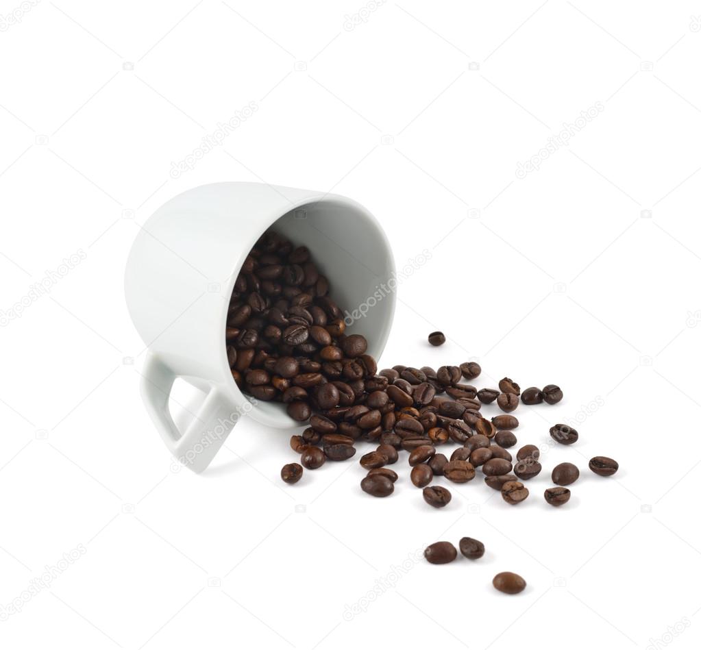 Spilled coffee beans from the cup isolated