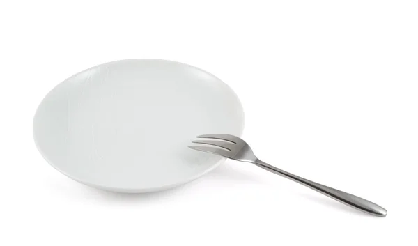 Metal fork in a ceramic plate isolated — Stock Photo, Image