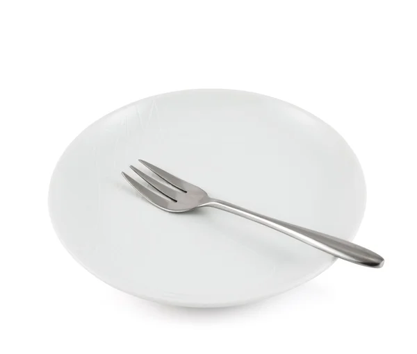 Fém villát egy elszigetelt kerámia tányér — Stock Fotó