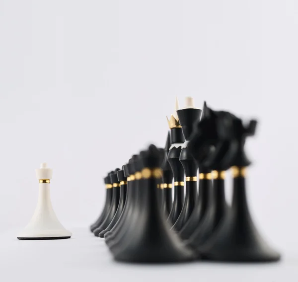 White chess pawn opposite to black ones — Stock Photo, Image
