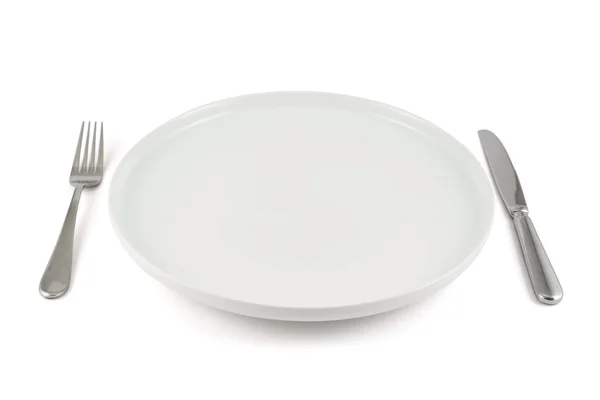 Table knife, fork and ceramic plate isolated