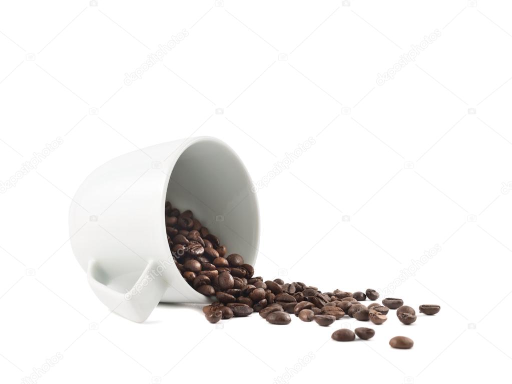 Spilled coffee beans from the cup isolated