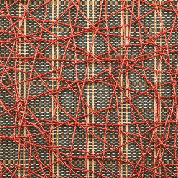 Bamboo mat covered with red thread — Stock Photo, Image