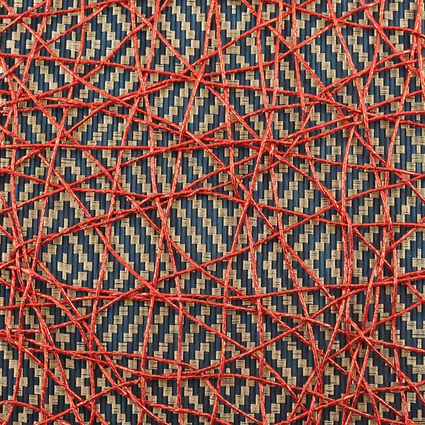 Bamboo mat covered with red thread — Stock Photo, Image