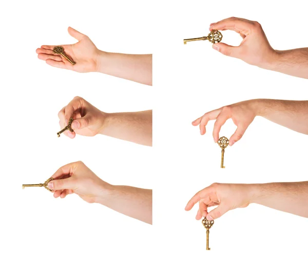 Mão segurando uma chave isolada — Fotografia de Stock
