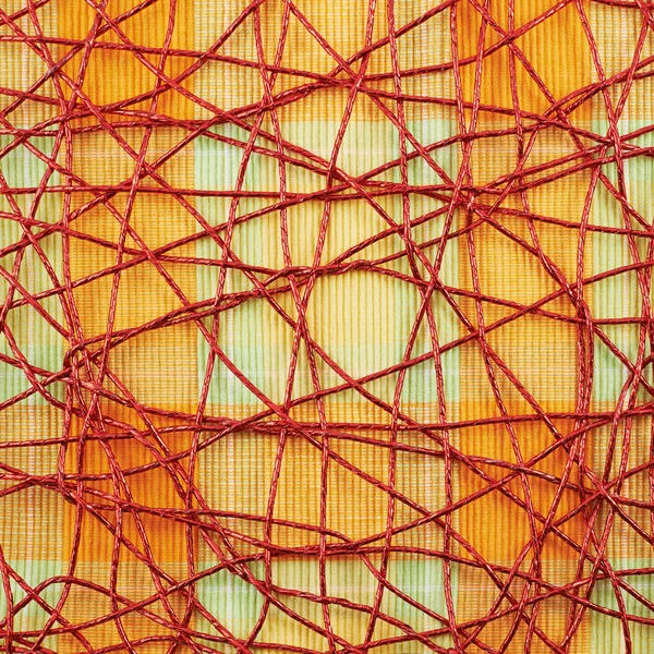 Estera de tela cubierta con hilo rojo — Foto de Stock
