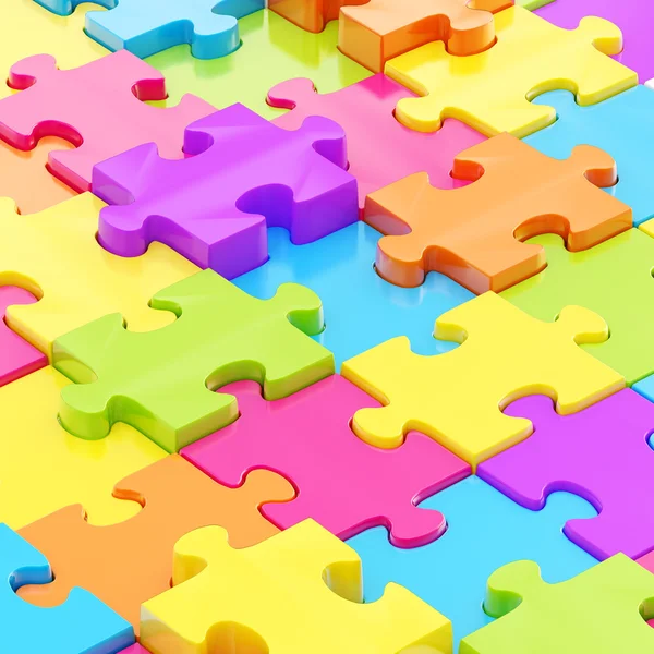 Красочные кусочки головоломки покрывают поверхность как абстрактную фоновую композицию — стоковое изображение Поверхность покрыта головоломками — стоковое фото