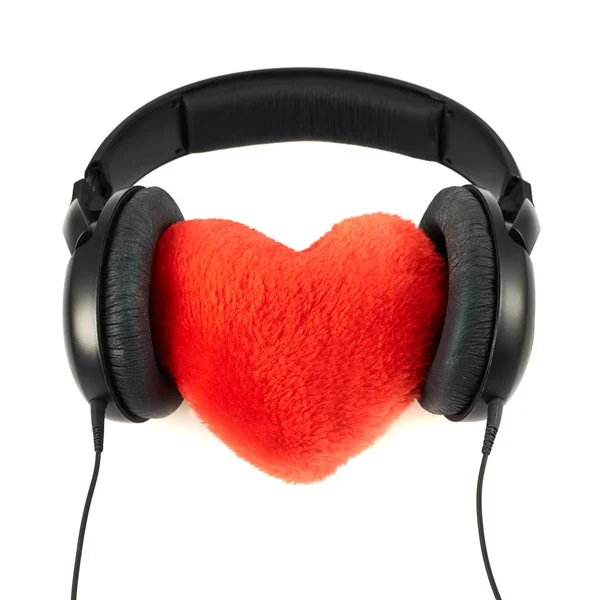 Fones de ouvido colocar em um coração de pelúcia — Fotografia de Stock