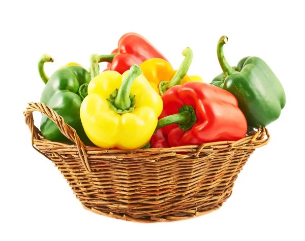 Wicker basket full of bell peppers — Stock Photo, Image