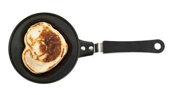 Heart shaped flapjack pancake in a pan Royalty Free Stock Images