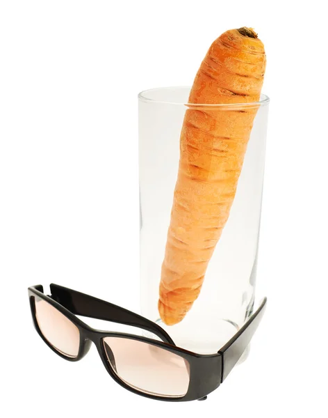 Glasses next to a carrot in a glass — Stock Photo, Image