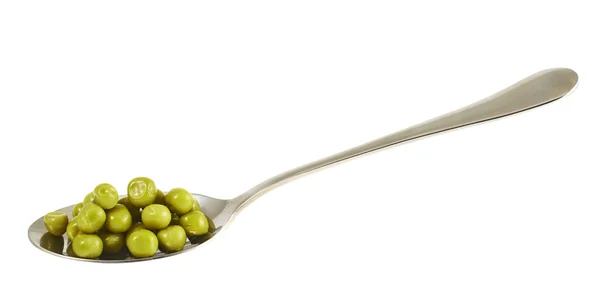 Steel spoon full of green peas isolated — Stock Photo, Image