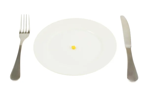 Plate with a single corn kernel isolated — Stock Photo, Image