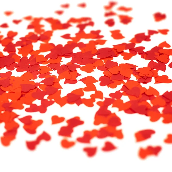 Scattered heart shaped red confetti — Stock Photo, Image