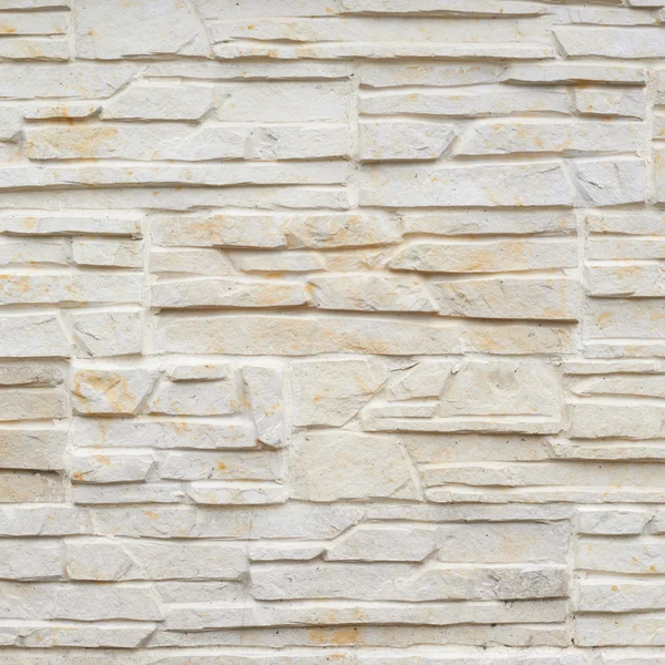 Wall of carved limestone bricks — Stock Photo, Image