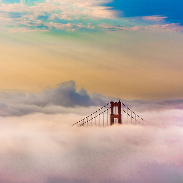 World Famous Golden Gate Bridge Surrounded by Fog after Sunrise in San Francisco, Californiaa
