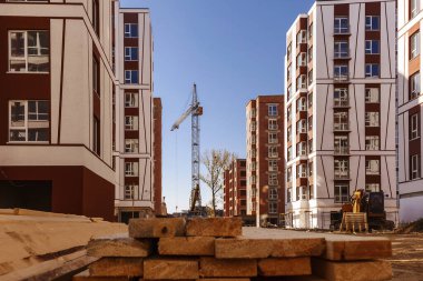 construction site, building in new residential neighborhood. Crane and tall skyscraper.