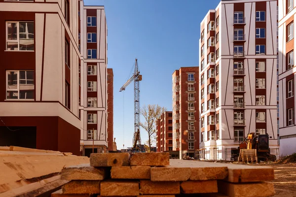 construction site, building in new residential neighborhood. Crane and tall skyscraper.