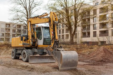 İnşaat alanında çalışan kovalı kazıcı buldozer. Tekerlekli kazıcı seviyeleri.