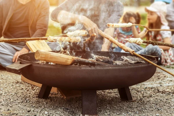 Bread on Sticks Stockbrot on Bonfire in Family Weekend in Germany Stick Bread twisted on stick