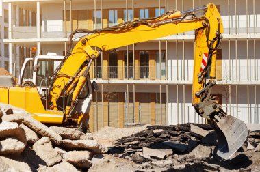 Bulldozer Loading Concrete Waste and Demolition Debris for recycling at construction site. Demolition Old Asphalt