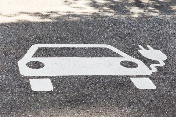 Charging Sign for Electric Car. Electric Car Parking Sign on Asphalt Background. Electric Vehicle Charging Station Sign.