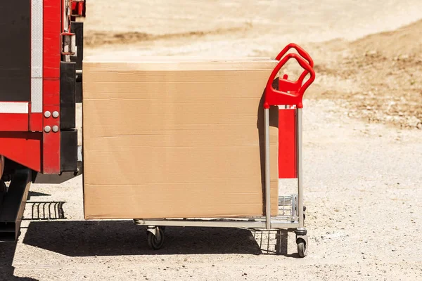 Delivery Carrying Cardboard Box in Hand Truck Trolley from Van. Delivery Parcel to any place any time. Post Service