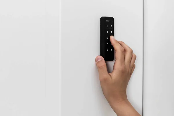 Electronic Key, Digital Door Lock. Hand pushing Code on Electronic Door Lock.