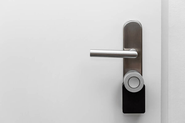 Electronic door handle installed on wood door. Door with digital door lock systems best security protection for apartment. 