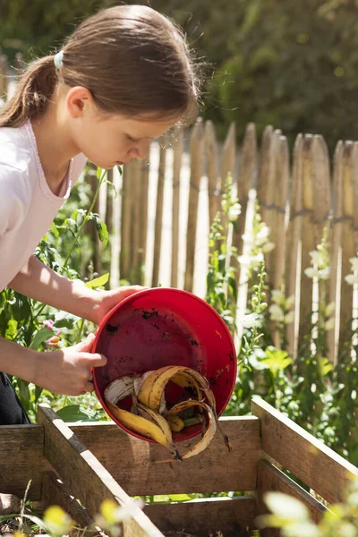 Recycling Organic Waste. Girl throwing organic in Compost Bin.  Bio Compost, Eco Fertilizer, Humus concept.