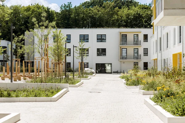Modern low rise european apartment building complex with outdoor facilities and new garden.