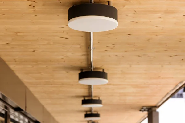 Wooden Ceiling with Ceiling Lamps Outside. Lamps on Ceiling in Terrace or Balcony Outdoor. Modern Ceiling Lamp Light.