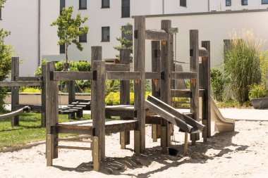 Modern wooden playground in new suburban residential complex