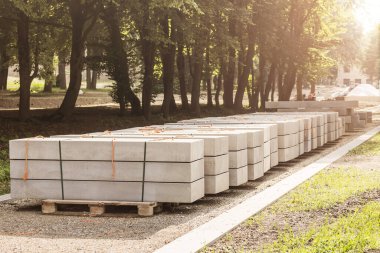 Concrete Paving blocks, Footpath Block on pellets in Park. Sidewalk construction in park