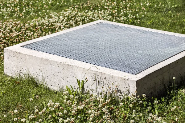 Ventilation system Outlet on Ground Lawn. Air Conditioning and Underground Vent Construction