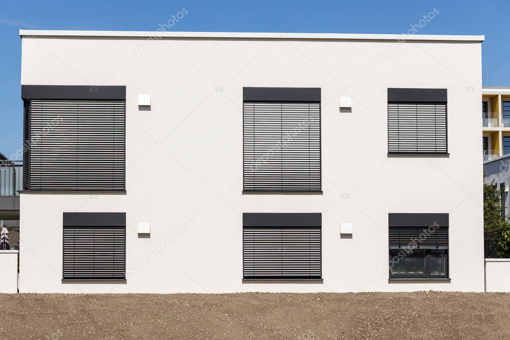 Blinds on Windows of Modern House. Modern Exterior Facade of Apartment Building with Roller Shutters and Flat Roof. 