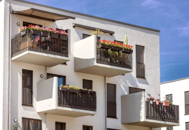 Balcony Flowers. Modern Facade Building with Decorated Balconies. 