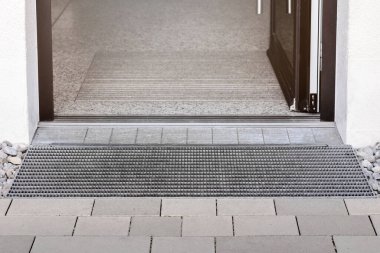 Drainage Grid, Drain Water,  front Entrance Door. Entry Drainage Floor and Drain Grate. Water Drain Mesh close up.